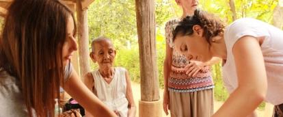 Medicine interns examine a local woman during a medical outreach in Cambodia. A Cambodian woman is examined by Projects Abroad medical interns during a community outreach.